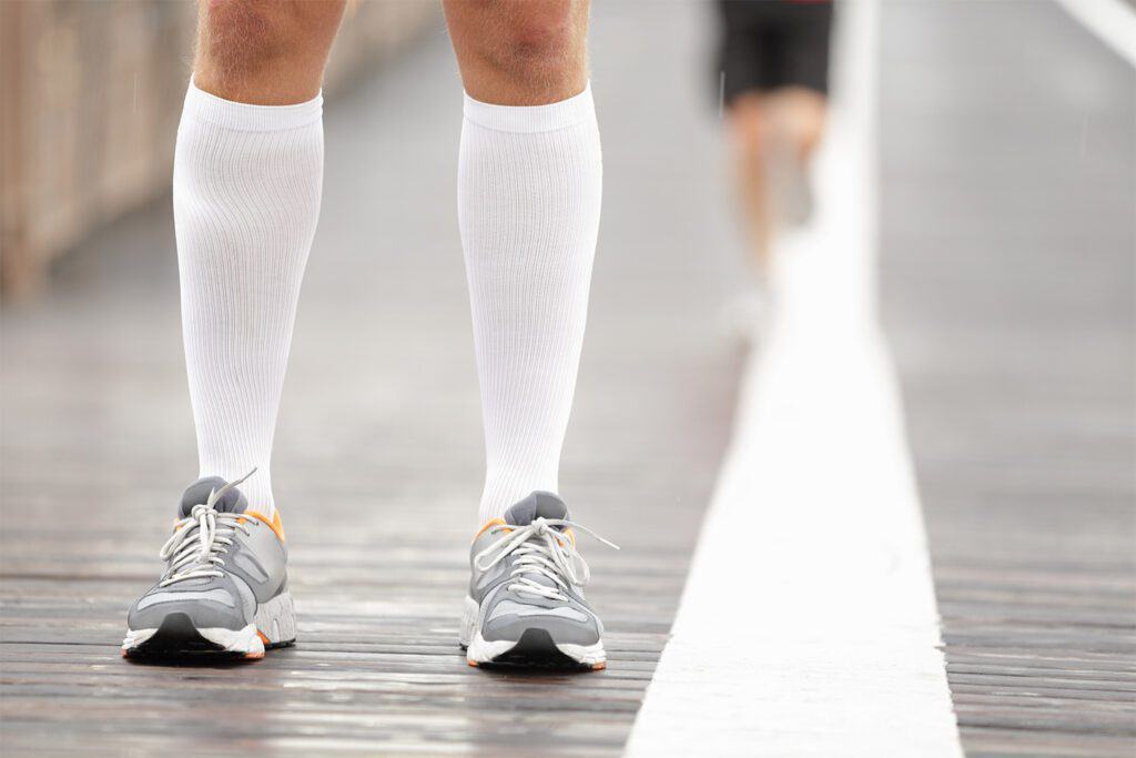 man wearing compression socks to prevent deep vein thrombosis