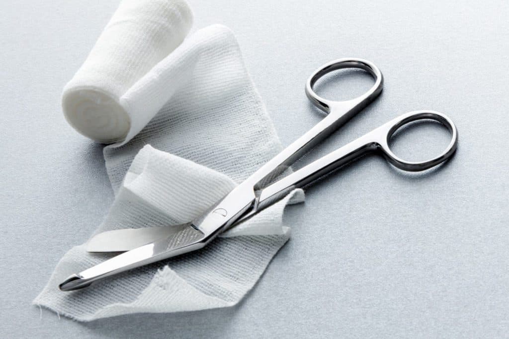 bandage and surgical scissors for extremity wound care
