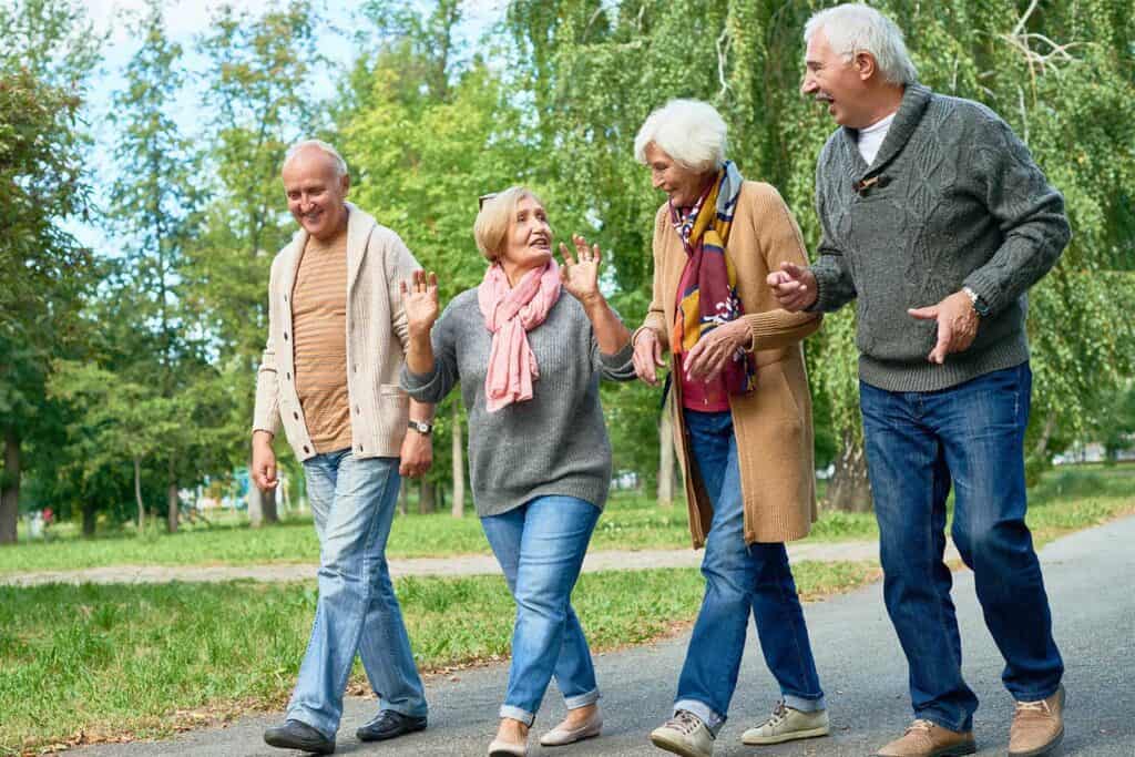 senior adults walking together outside to prevent post thrombotic syndrome