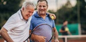 men playing tennis and keeping active to minimize the risk of a thoracic aneurysm .