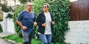 mature couple jogging to prevent aortic aneurysm.