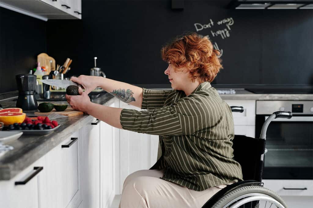 disabled woman in a wheelchair cutting avocados