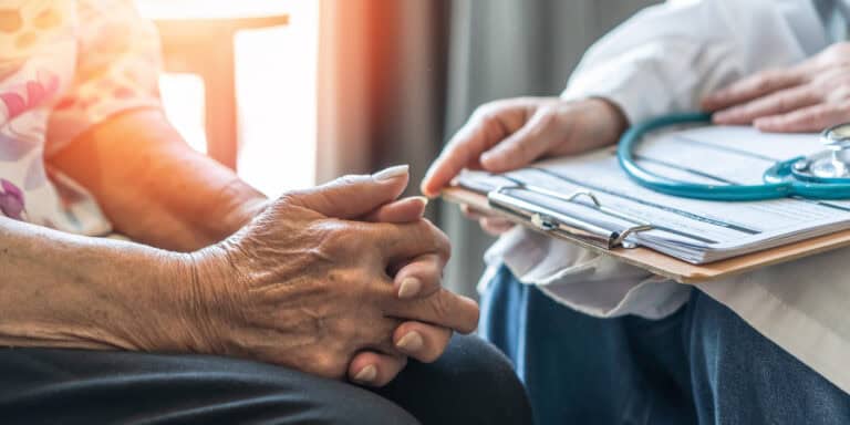 Hands of a doctor and elderly patient