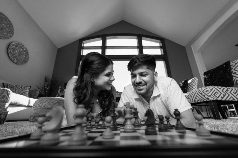 man and woman playing chess