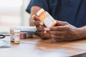 Home healthcare nurse reviews medication with patient