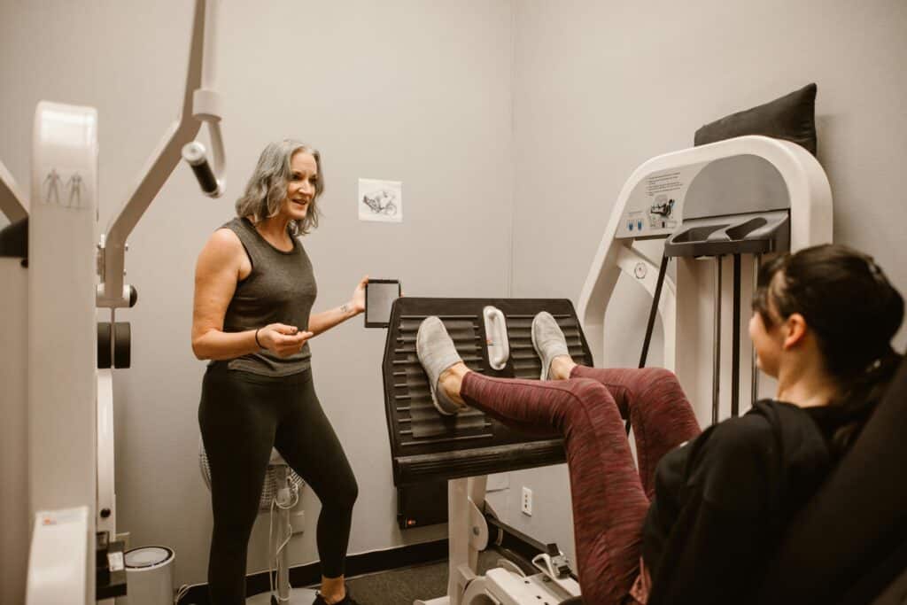 2 women doing leg press exercises together