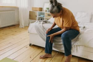 elderly woman grabbing leg
