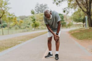 man holding his leg due to pain