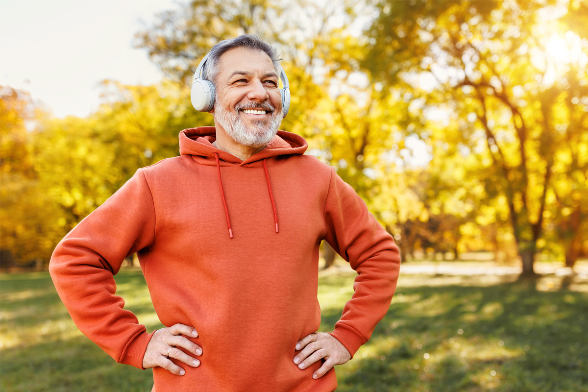 Man listening to music in a park. 