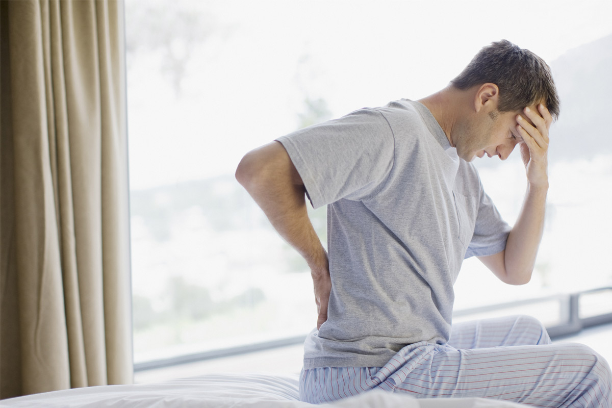 man having back pain and headache. 