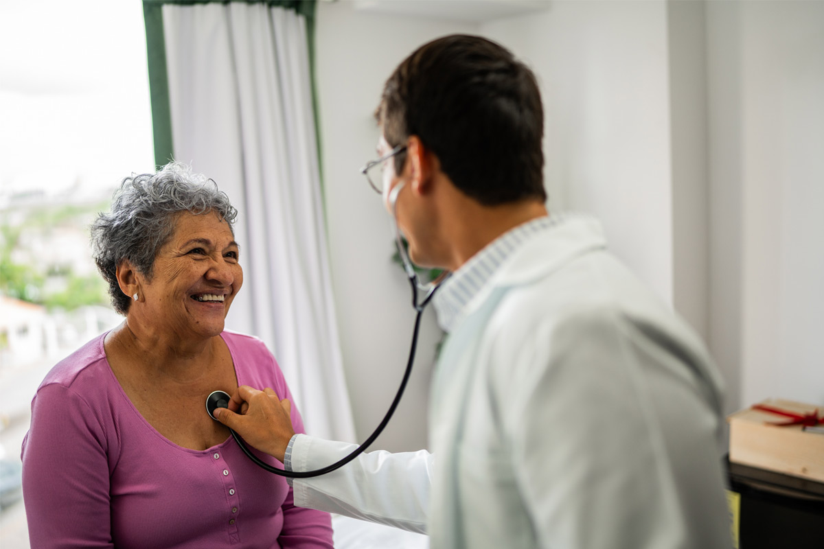 doctor checking patient's heart beat.