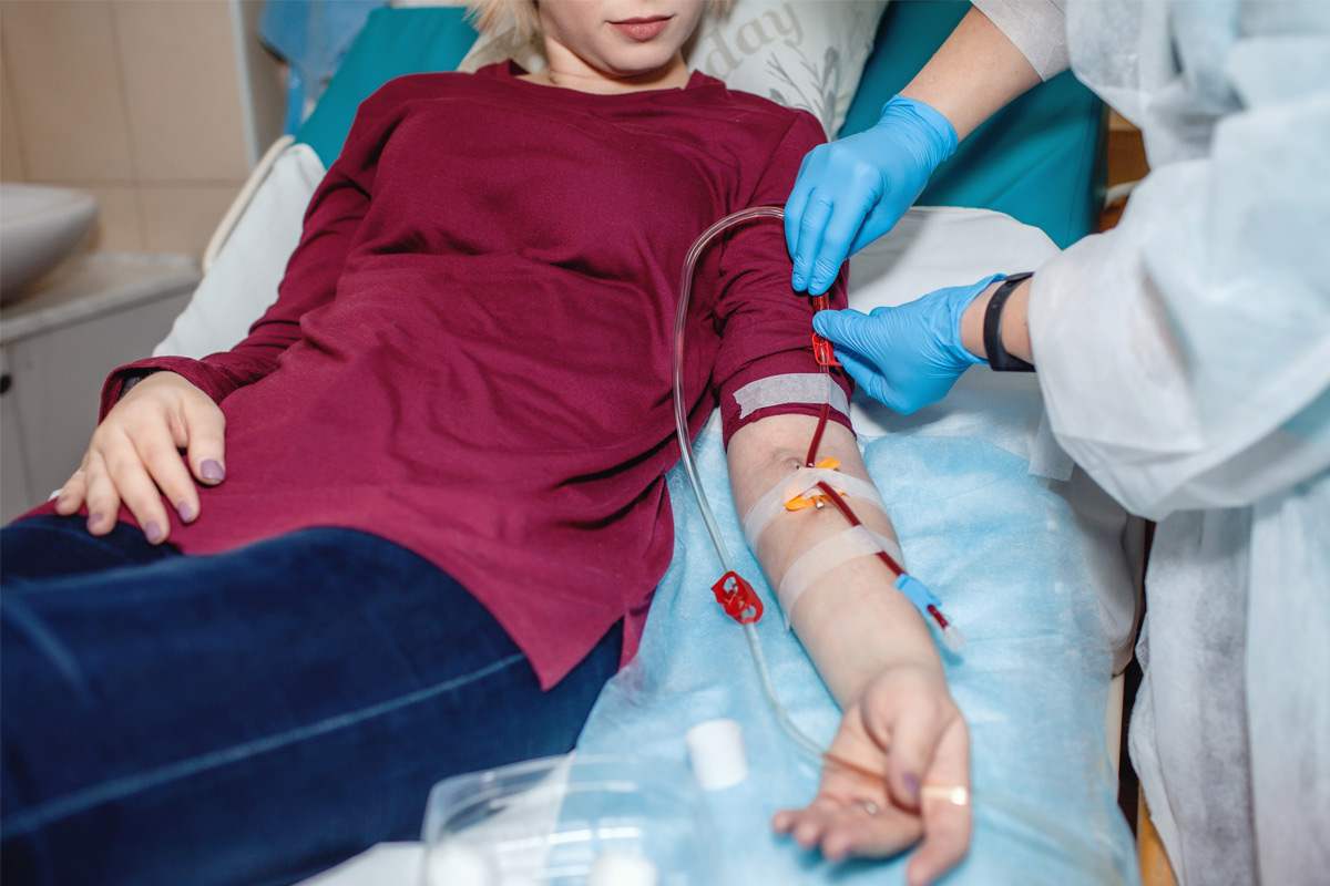 doctor taking blood from patient in a doctor's clinic