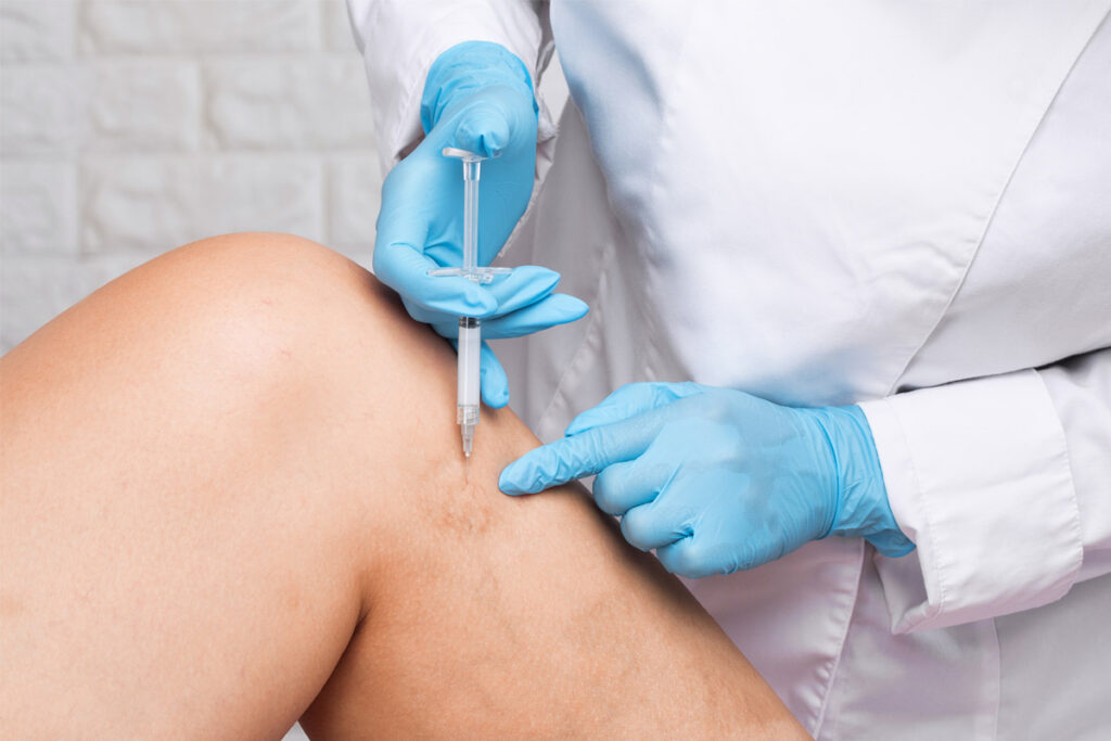 doctor putting injection in legs.