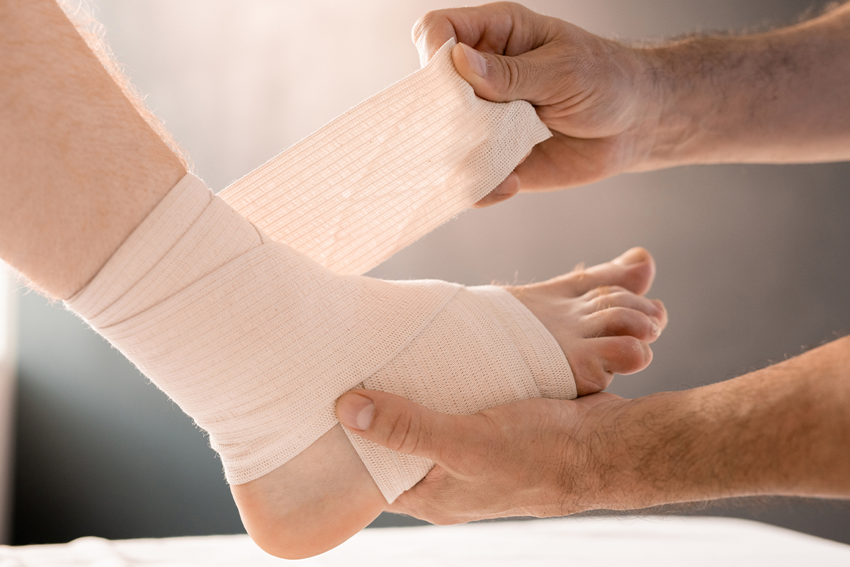 doctor bandaging ankle wound