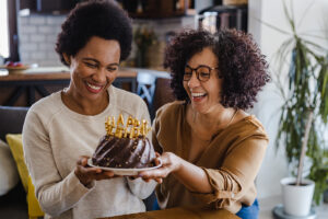 Two women celebrating an occasion with cake