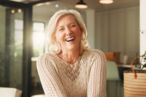 Older woman smiling happily.