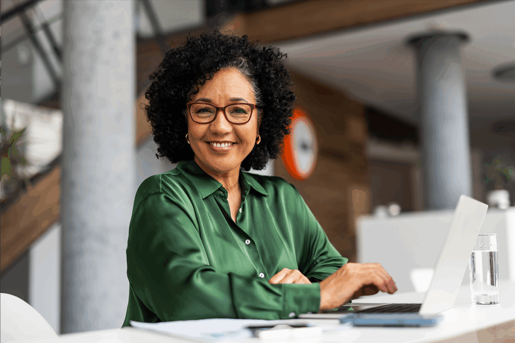 A woman sitting at a counter on her laptop