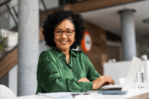 A woman sitting at a counter on her laptop