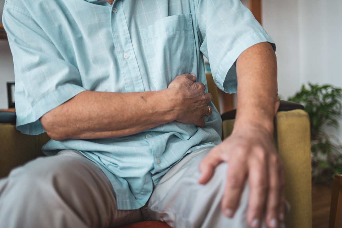 Close up on old man holding the spot of the pain