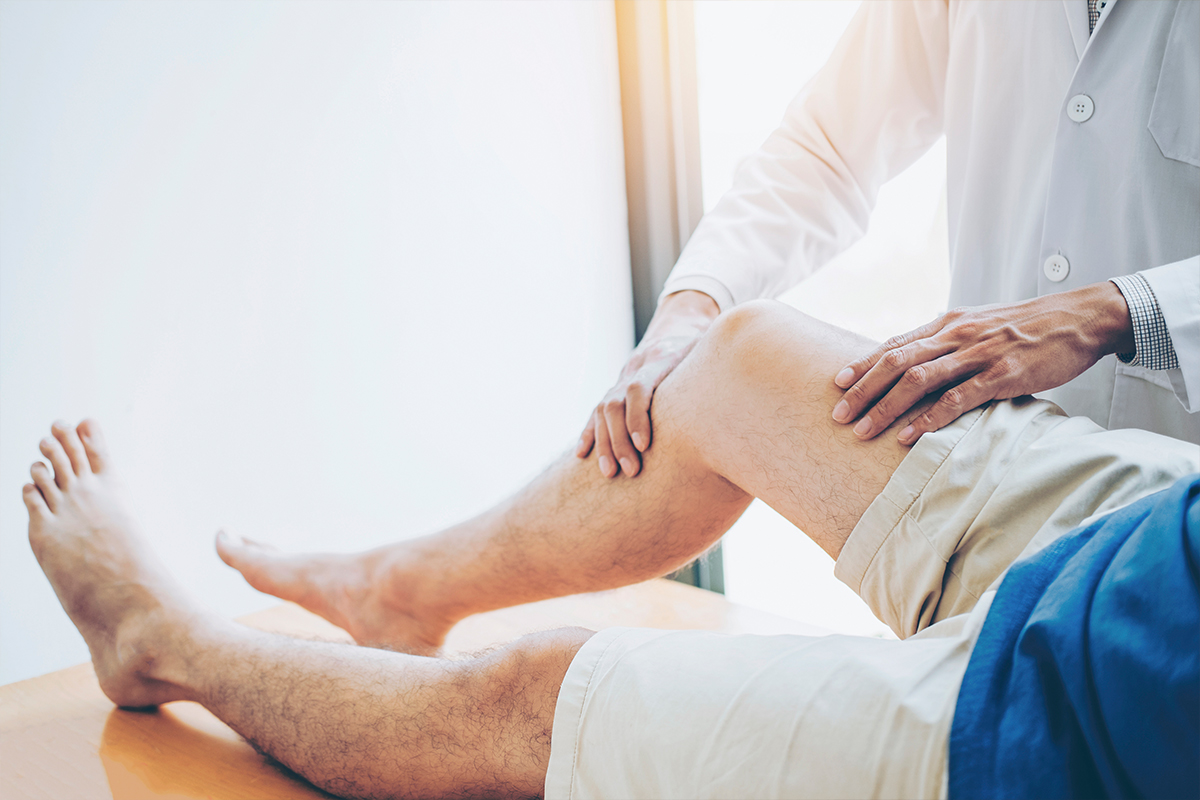 Person having their knee checked by a physician