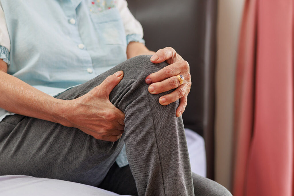 Man holding knee in pain