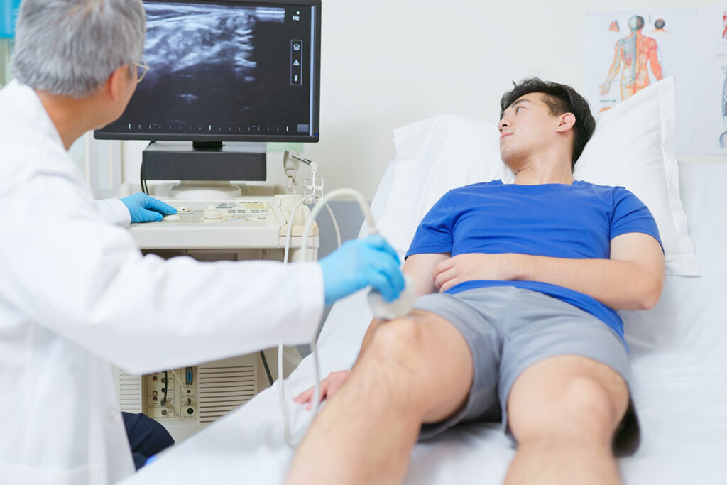 Doctor performs ultrasound on knee