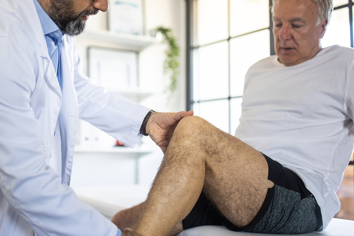 doctor evaluating man's leg condition
