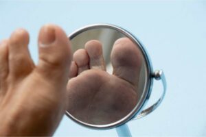 Person inspecting foot