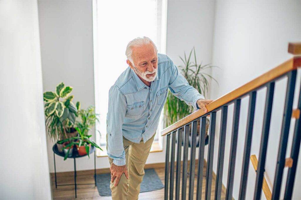 Man experiencing pain climbing stairs