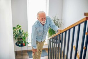 Man experiencing pain climbing stairs